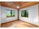 Bedroom with wood floors, ceiling fan and nature views at 1205 Sutton Trl, Geneva, FL 32732