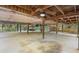 Covered parking area under house with concrete floor and ceiling fan at 1205 Sutton Trl, Geneva, FL 32732