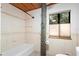 Bright bathroom with shower/tub combo and tile surround at 1205 Sutton Trl, Geneva, FL 32732