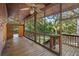 Spacious screened porch with wooden floors and ceiling fan at 1205 Sutton Trl, Geneva, FL 32732