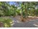 Landscaped backyard with picnic table and tropical plants at 1205 Sutton Trl, Geneva, FL 32732