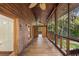 Long screened porch with wooden floors and access to backyard at 1205 Sutton Trl, Geneva, FL 32732