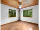 Bedroom with wood floors, ceiling fan and nature views at 1205 Sutton Trl, Geneva, FL 32732