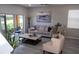 Spacious living room with hardwood floors, neutral tones, and access to a patio at 1002 Calabria Ave, Davenport, FL 33897