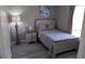 Charming bedroom with a wooden bed frame, nightstand and neutral color palette at 1002 Calabria Ave, Davenport, FL 33897