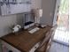 Home office with a wooden desk, computer, and sliding glass door access at 1002 Calabria Ave, Davenport, FL 33897