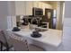Modern kitchen with white cabinets and stainless steel appliances at 1002 Calabria Ave, Davenport, FL 33897
