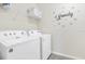 Laundry room with washer, dryer, and shelving at 1870 Sawyer Palm Pl, Kissimmee, FL 34747