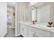 Bathroom with vanity, red faucet, and striped wallpaper at 1870 Sawyer Palm Pl, Kissimmee, FL 34747