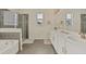 Spa-like bathroom with double vanity, soaking tub, and walk-in shower at 1870 Sawyer Palm Pl, Kissimmee, FL 34747