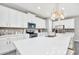 Modern kitchen with white cabinets, quartz countertops, and stainless steel appliances at 1870 Sawyer Palm Pl, Kissimmee, FL 34747