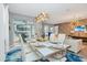 Modern dining room with a large table, chandelier, and access to a patio at 1870 Sawyer Palm Pl, Kissimmee, FL 34747