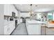Modern kitchen with white cabinets, quartz countertops, and stainless steel appliances at 1870 Sawyer Palm Pl, Kissimmee, FL 34747