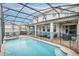 Inviting pool and spa with a screened enclosure at 1870 Sawyer Palm Pl, Kissimmee, FL 34747