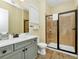 Modern bathroom with walk-in shower and updated vanity at 8024 Surf St, Kissimmee, FL 34747