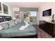 Spacious main bedroom with water view, king-size bed, and private balcony at 17401 Serenidad Blvd, Clermont, FL 34714