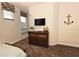 Cozy bedroom with window seat, dresser, and a mounted TV at 17401 Serenidad Blvd, Clermont, FL 34714
