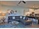 Open living room with sectional sofa, modern decor, and kitchen access at 17401 Serenidad Blvd, Clermont, FL 34714