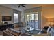 Living area with sectional sofa, access to patio and pool, and modern decor at 17401 Serenidad Blvd, Clermont, FL 34714