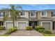Two-story townhome with two-car garage and lush landscaping at 2663 River Landing Dr, Sanford, FL 32771
