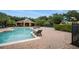 Community pool with lounge chairs and nearby playground at 2663 River Landing Dr, Sanford, FL 32771