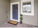 Front door entry to townhome with a welcome mat and potted plants at 2663 River Landing Dr, Sanford, FL 32771
