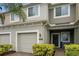 Two-story townhome with a two-car garage and manicured landscaping at 2663 River Landing Dr, Sanford, FL 32771