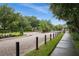 Gated entrance to the community with paved road and sidewalk at 2663 River Landing Dr, Sanford, FL 32771
