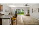 Open living room with kitchen, island, and access to backyard at 2663 River Landing Dr, Sanford, FL 32771