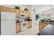 Updated kitchen featuring white appliances and wood cabinets at 475 Windsor Pl, Davenport, FL 33896