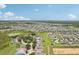 Aerial view of a residential neighborhood showcasing houses and green landscape at 475 Windsor Pl, Davenport, FL 33896