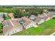 Aerial view of houses with pools and screened enclosures in a residential area at 475 Windsor Pl, Davenport, FL 33896