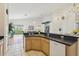 Modern kitchen with a breakfast bar and views of the living area at 475 Windsor Pl, Davenport, FL 33896