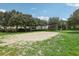 Outdoor sand volleyball court nestled amongst lush greenery at 475 Windsor Pl, Davenport, FL 33896