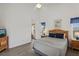 Bedroom with a queen bed, dresser, and access to exterior at 475 Windsor Pl, Davenport, FL 33896