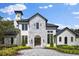 Stunning two-story home with a tile roof, arched entryway, and landscaped grounds at 5518 Worsham Ct, Windermere, FL 34786