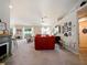 Bright living room with a red sofa, fireplace, and Gathering photos at 318 Stone Castle Loop, Lady Lake, FL 32159