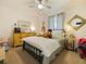 Charming bedroom with yellow dresser and metal bed frame at 318 Stone Castle Loop, Lady Lake, FL 32159
