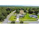 Aerial view of a home with a pool and well-maintained landscaping at 318 Stone Castle Loop, Lady Lake, FL 32159