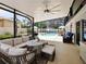Enjoy this screened lanai with seating and a view of the pool at 318 Stone Castle Loop, Lady Lake, FL 32159