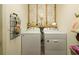 Convenient laundry room with washer and dryer, and shelving at 318 Stone Castle Loop, Lady Lake, FL 32159