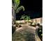 Landscaped backyard with a lighted pathway at night at 318 Stone Castle Loop, Lady Lake, FL 32159