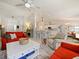 Open living room featuring a cozy fireplace and an adjacent kitchen at 318 Stone Castle Loop, Lady Lake, FL 32159