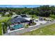 Aerial view showing home with solar panels and pool area at 318 Stone Castle Loop, Lady Lake, FL 32159