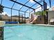 Screened pool area with water feature, slide, and patio furniture at 318 Stone Castle Loop, Lady Lake, FL 32159