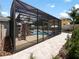 Screened pool enclosure with a view of the pool and patio at 318 Stone Castle Loop, Lady Lake, FL 32159