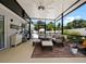Relaxing screened lanai with comfortable seating and outdoor rug at 318 Stone Castle Loop, Lady Lake, FL 32159