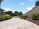Expansive paved patio and walkway leading to a fenced backyard at 318 Stone Castle Loop, Lady Lake, FL 32159