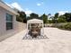 Outdoor patio dining area with striped umbrella and rug at 318 Stone Castle Loop, Lady Lake, FL 32159