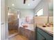 Relaxing bathroom with corner soaking tub and walk-in shower at 318 Stone Castle Loop, Lady Lake, FL 32159